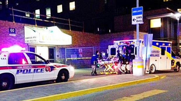 An ambulance arrives at a trauma centre in Toronto after transporting a person who was shot in a police-involved shooting in Aurora Saturday, April 12, 2014. (Tom podolec/CP24)