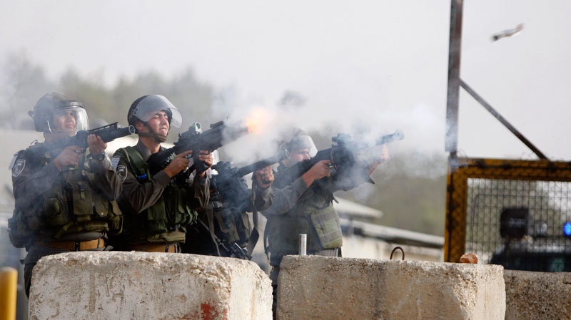Israeli security forces fire teargas at Palestinians during clashes outside Israeli military prison Ofer near the West Bank city of Ramallah. Friday, Oct. 21, 2011. (AP / Majdi Mohammed)