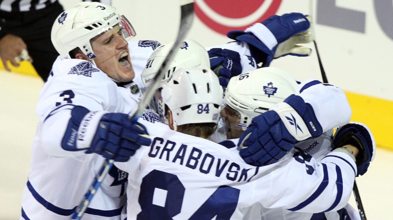 Toronto Maple Leafs center Mikhail Grabovski (84) celebrates with teammates Dion Phaneuf (3), Clarke MacArthur (16) and Nikolai Kulemin (41) after scoring the fourth goal against the Montreal Canadiens during third period National Hockey League action Saturday, October 22, 2011 in Montreal.