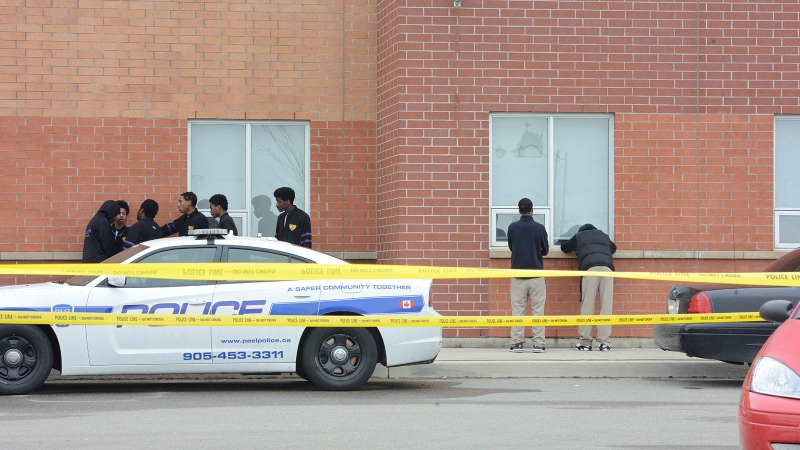 Peel police attend to the scene of a stabbing at St. Roch Catholic Secondary School in Brampton, Ont., Tuesday, April 15, 2014. (CTV Toronto / Andrew Collins)