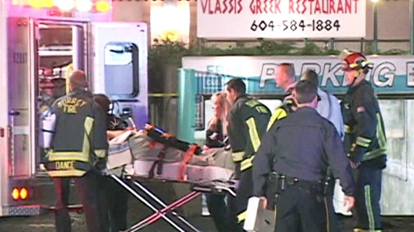 A man is placed in an ambulance by emergency officials following a shooting in Surrey, B.C. on Saturday, Oct. 22, 2011.