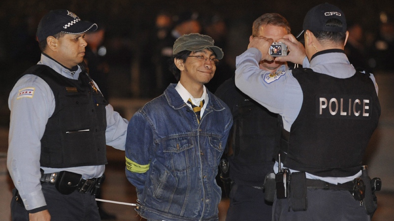 A protester gets arrested during an Occupy Chicago march and protest in Grant Park in Chicago, Sunday, Oct. 23, 2011. (AP Photo/Paul Beaty)