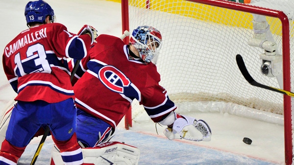 Montreal Canadiens goalie Peter Budaj and Mike Cammalleri watch the puck go into the net on a goal by Florida Panthers' Tomas Fleischmann during first period NHL hockey action Monday, October 24, 2011 in Montreal. THE CANADIAN PRESS/Paul Chiasson