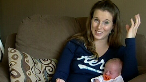 Emily Ratcliffe holds new daughter Mariah, who was born in the family living room. Ratcliffe did not realize she was pregnant. Oct. 24, 2011. (CTV)