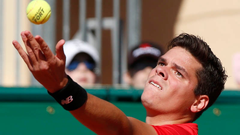 Milos Raonic of Canada, serves the ball to Tommy R