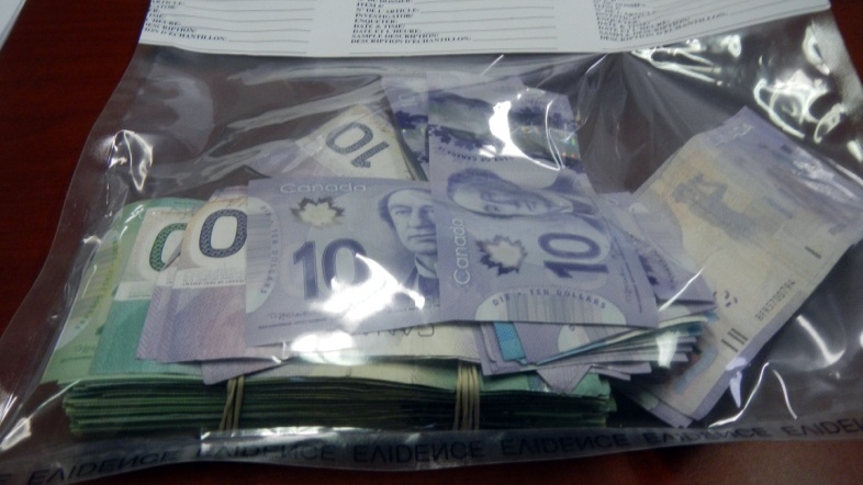 Police said a "large amount" of cash was seized during a drug bust at a Prince Albert home Wednesday. (Prince Albert police)