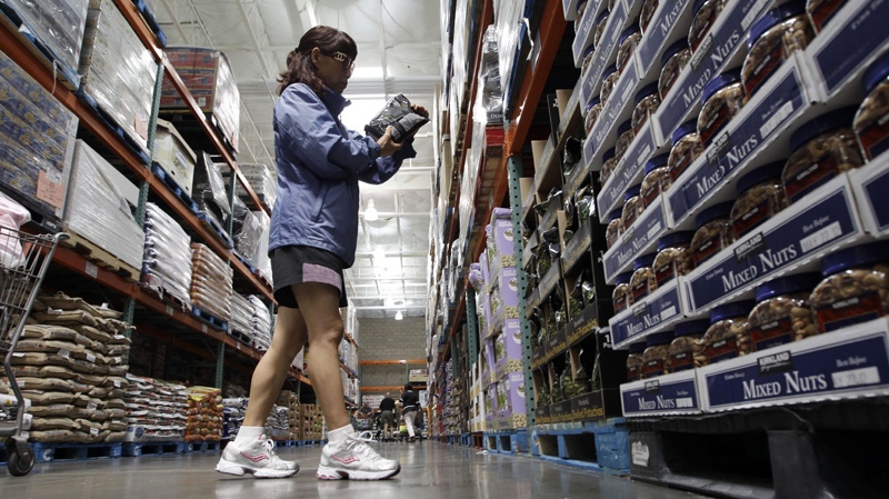 This Sept. 2, 2011 file photo, shows a shopper reading a product label at Costco Wholesale in Mountain View, Calif. (AP Photo/Paul Sakuma, File)