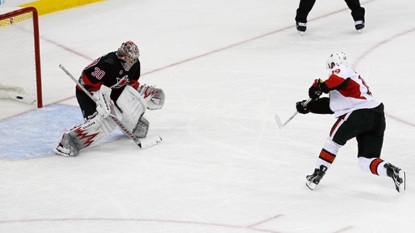 Ottawa Senators' Jason Spezza (19) scores on Carolina Hurricanes goalie Cam Ward (30) during the shootout in an NHL hockey game in Raleigh, N.C., Tuesday, Oct. 25, 2011. Ottawa won 3-2.