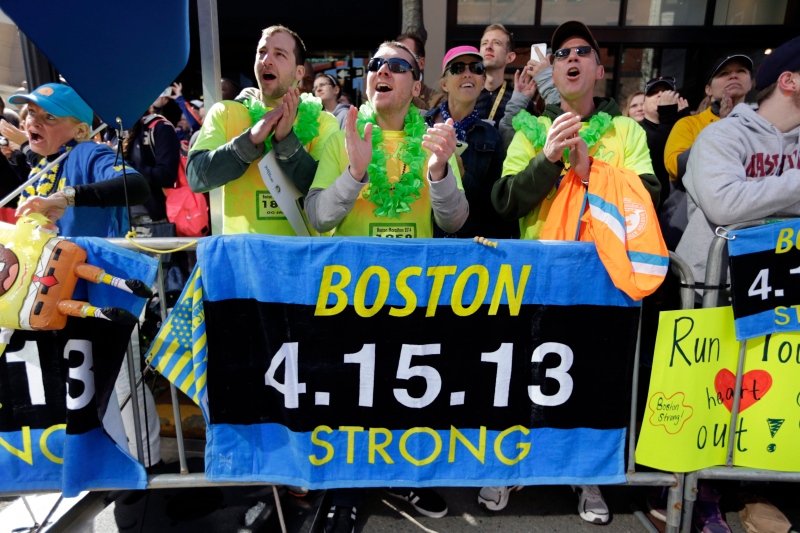 Race fans, from left, Andrew Lembecke, Brandon Petrich, Marlene Youngblood and Bill Januszewski cheer near the finish line at the 118th Boston Marathon Monday, April 21, 2014. (AP Photo/Robert F. Bukaty)