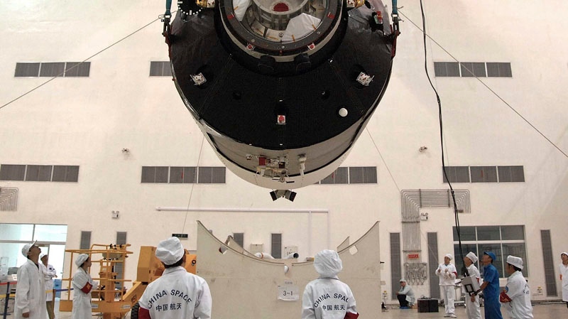 In this undated photo shows researchers installing China's first space station module Tiangong-1 inside the Jiuquan Satellite Launch Center in northwest China's Gansu Province, on the edge of the Gobi Desert. China launched the experimental module on Thursday, Sept. 29 to lay the groundwork for a future space station underscoring its ambitions to become a major space power. 