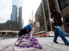 A homeless person panhandles for money in Toronto on Monday, Dec. 13, 2010. (Nathan Denette / THE CANADIAN PRESS)