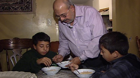 Farid Suleiman takes care of his children before he heads to his parent's home to help take care of them as well, Thursday, Oct. 27, 2011. 