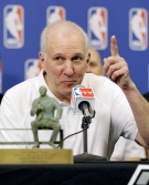 San Antonio Spurs coach Gregg Popovich sits with the Red Auerbach trophy during a news conference after he was named NBA basketball coach of the year, Tuesday, April 22, 2014, in San Antonio. Popovich has won the award three times. (AP / Eric Gay)