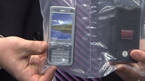 Vancouver police display a Taser disguised as a cell phone that was seized during a kidnapping investigation. Oct. 28, 2011. (CTV)