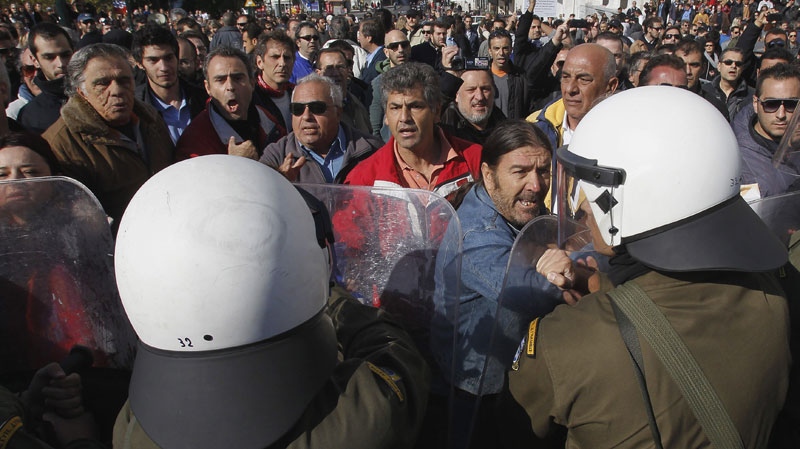 Anti-austerity protesters scuffle with riot police in Athens on Oct. 28, 2011