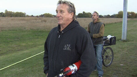Ron Rubuliak grabbed a fire extinguisher and ran towards the plane crash to help passengers onboard. Oct. 28, 2011. (CTV)