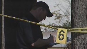 Police investigate the fatal shooting in October 2010 in Winnipeg along Selkirk Avenue. 