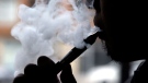 Daryl Cura demonstrates an e-cigarette at Vape store in Chicago, Wednesday, April 23, 2014.  (AP Photo/Nam Y. Huh)