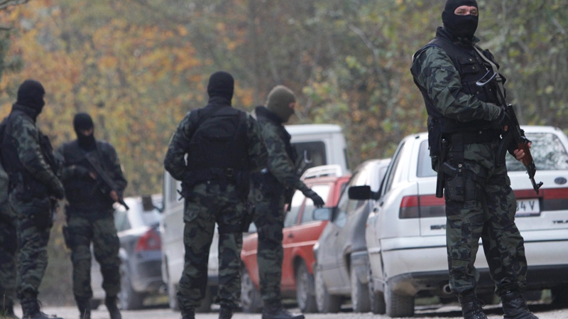 Bosnian Special police units check personal ID of the residents on the road towards Bosnian village of Gornja Maoca, 200 kms north from Sarajevo, on Saturday, Oct. 29, 2011. (AP / Amel Emric)