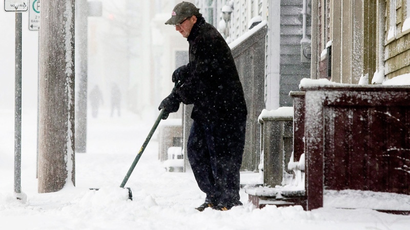 An unidentified man shovels his walk in Halifax on Sunday, Jan. 9, 2011. (Andrew Vaughan / THE CANADIAN PRESS)