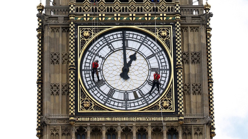 In this Thursday, Aug. 12, 2010 file photo, workers check and repair the external glazing on one of the four faces of the Great Clock on the clock tower, colloquially known as Big Ben after its massive bell, at the Palace of Westminster in London. (AP Photo/Sang Tan, file)