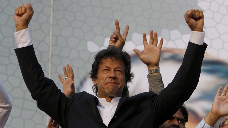 Pakistani cricketer turned politician and head of Pakistan Tahreek-e-Insaf or Movement for Justice Party Imran Khan waves to his supporters during a rally in Lahore, Pakistan on Sunday, Oct. 30, 2011. (AP Photo/K.M. Chaudary)