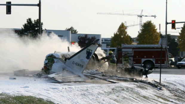 Firefighters attend the scene of a plane crash in Richmond, B.C. on Thursday Oct. 27, 2011. (Steve Smith / THE CANADIAN PRESS)