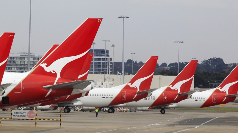 The tails of Qantas planes are lined up at Sydney Airport in Sydney, Sunday, Oct. 30, 2011. (AP Photo/Rick Rycroft)