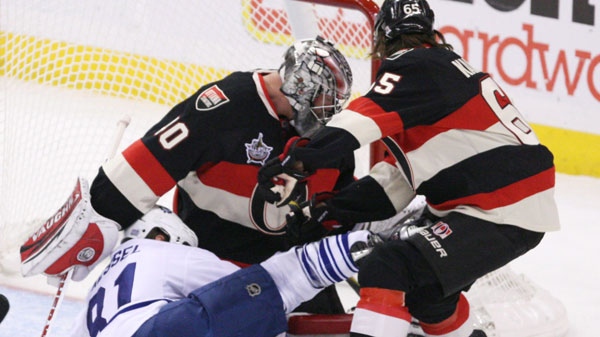 Torornto Maple Leafs' Phil Kessel (81) battles for a loose puck with Ottawa Senators' Erik Karlsson (65) and Ottawa goaltender Robin Lehner (40) during first period NHL hockey action in Ottawa, Sunday October 30, 2011.THE CANADIAN PRESS/Fred Chartrand