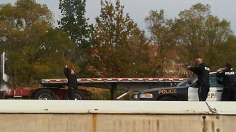 Twitter user Daman Singh shared this image of the truck driver suspect being confronted by police in Burlington, Ont., on Monday, Oct. 31, 2011.