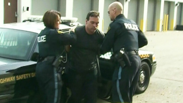 A truck driver who is suspected of stealing a tractor trailer and leading police on a five hour police chase is seen after being taken into police custody in Burlington, Ont., on Monday, Oct. 31, 2011.