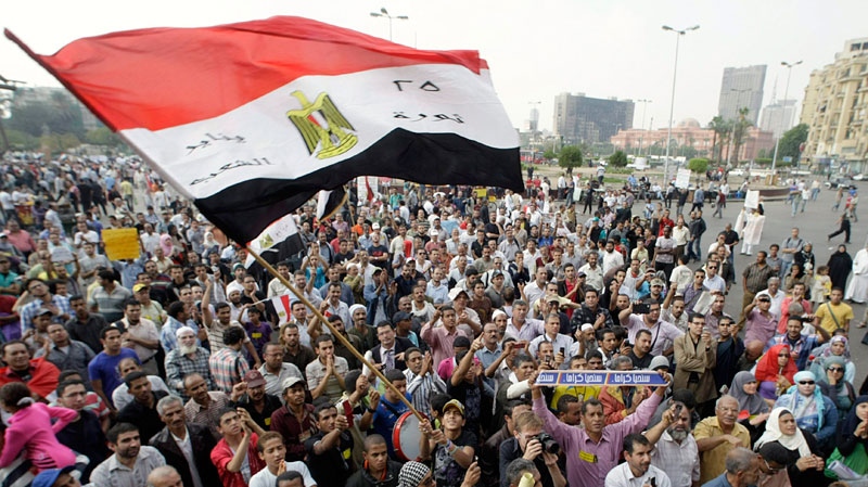 An Egyptian protester waves the national flag during a demonstration at Tahrir Square against the ruling military council, in Cairo, Egypt, Friday, Oct. 28, 2011. (AP / Amr Nabil)