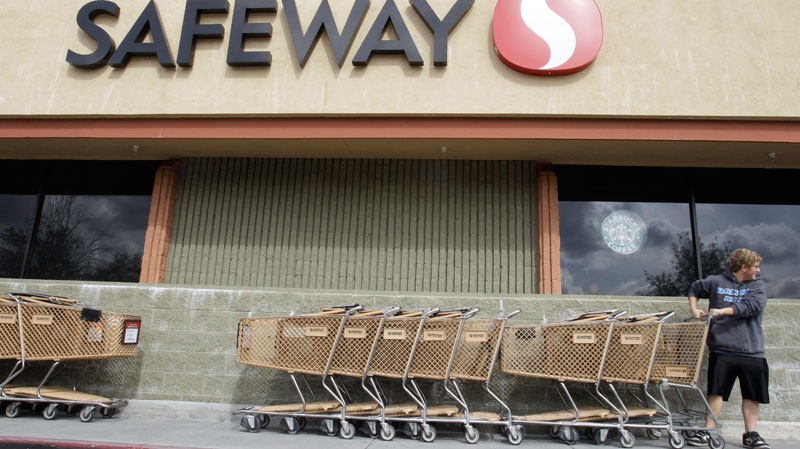 In this Feb. 23, 2011 photo, a customer grabs a shopping cart at a Safeway store in Cupertino, Calif. (AP / Paul Sakuma)