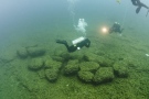 Divers examine boulders on the bottom of Lake Huron near Alpena, Mich., that were used as caribou drive lanes by prehistoric hunters in this June 13, 2011 file photo, provided by Thunder Bay National Marine Sanctuary via the University of Michigan News Service. (Thunder Bay National Marine Sanctuary / University of Michigan News Service / Tane Casserly)