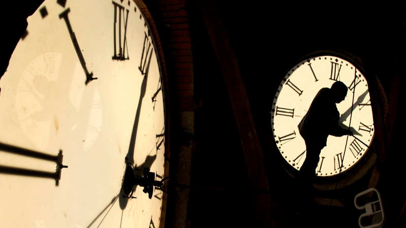 In this Nov. 6, 2010 file photo, custodian Ray Keen checks the time on a clock face after changing the time on the 97-year-old clock atop the Clay County Courthouse in Clay Center, Kan. Keen was setting time back an hour in advance of the end of daylight savings time which occurs at 2 a.m. on Sunday. 