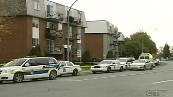 Longueuil police cars lined up outside 1425 Beauharnois St., where the bodies of a 30-year-old woman and her 13-year-old daughter were found (Nov. 4, 2011)
