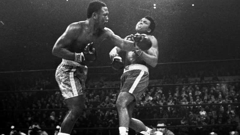 Boxer Joe Frazier, left, hits Muhammad Ali during the 15th round of their heavyweight title fight at New York's Madison Square Garden in this March 8, 1971 file photo. (AP, File) 