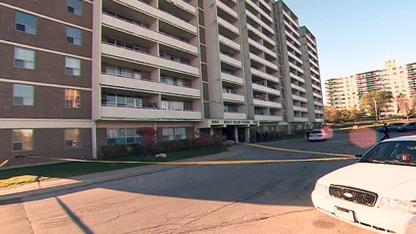 Police are shown at the scene where at least three people fell from the balcony of a highrise on Scarborough Golf Club Road near Lawrence Avenue East in Toronto on Saturday, Nov. 5, 2011.