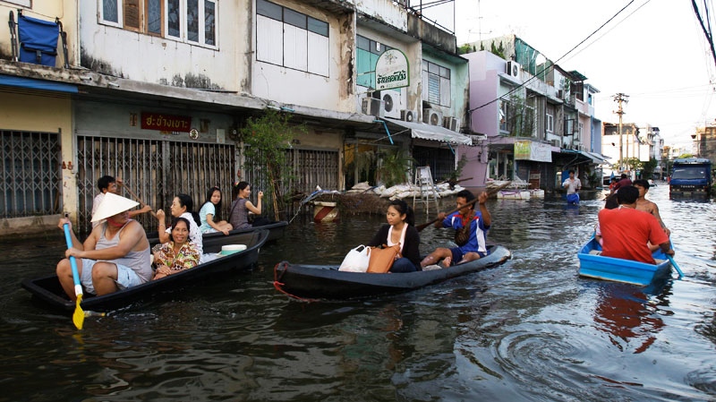 Thai residents use boats to navigate around their flooded community in Bangkok, Thailand, Sunday, Nov. 6, 2011. (AP / Aaron Favila)