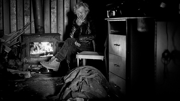Claude Lord sits next to his wood-burning stove to keep warm in his shipping container in Montreal. Lord, a military vet lives in a shipping container in a poor neighbourhood of Montreal. THE CANADIAN PRESS/Paul Chiasson