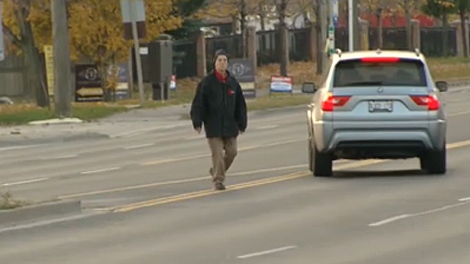 A man crossing the street, and not using a crosswalk, on Monday, Nov. 7, 2011.