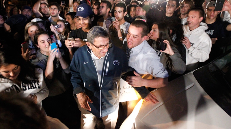 Students greet Penn State football coach Joe Paterno as he arrives at his home in State College, Pa., Tuesday, Nov. 8, 2011. (AP / Matt Rourke)
