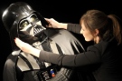 A Christie's employee adjusts a Darth Vader costume in this Oct. 27, 2010 file photo. (AP / Lennart Preiss)
