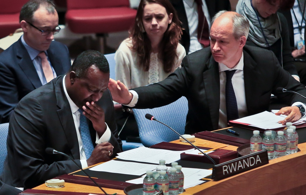 Peter Wilson comforts Eugene Gasana at UN
