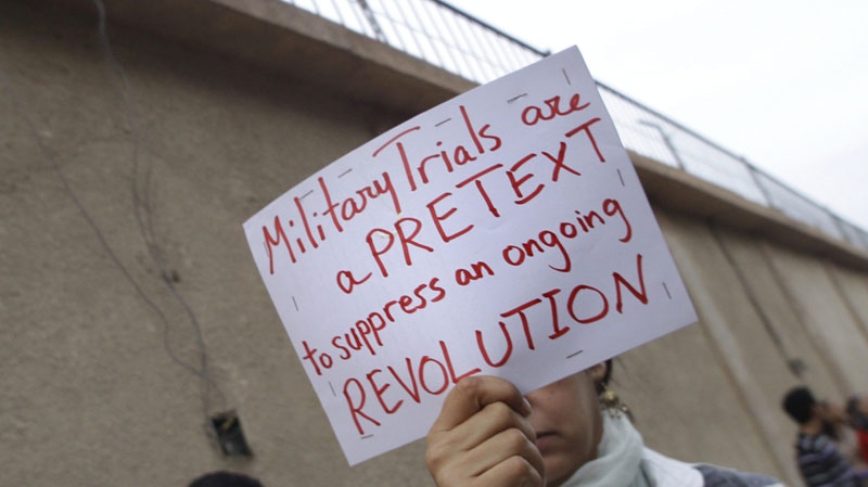 An Egyptian activist holds a sign out front of Cairo's Torah prison during a demonstration on Nov. 9, 2011