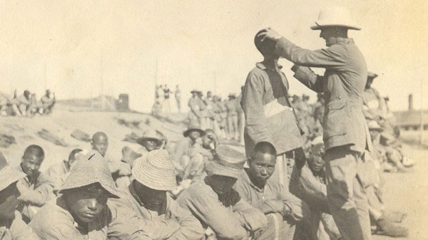 Capt. Harry Drummond Livingstone, of the Canadian Army Medical Corps, examining would-be recruits in Shandong Province in 1917. Livingstone examined men for diseases that could disqualify them, including tuberculosis, venereal disease and trachoma, a bacterial eye disease that can cause blindness. (Livingstone family)