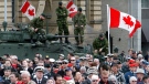 Soldiers stand on military armoured vehicles as people gather on Parliament Hiil in Ottawa during ceremonies for Canada's National Day of Honour, Friday, May 9, 2014. (Fred Chartrand / THE CANADIAN PRESS)
