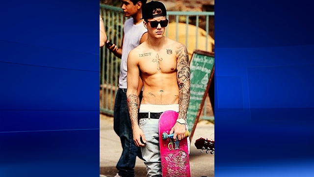 Bieber holds onto moving while skateboarding