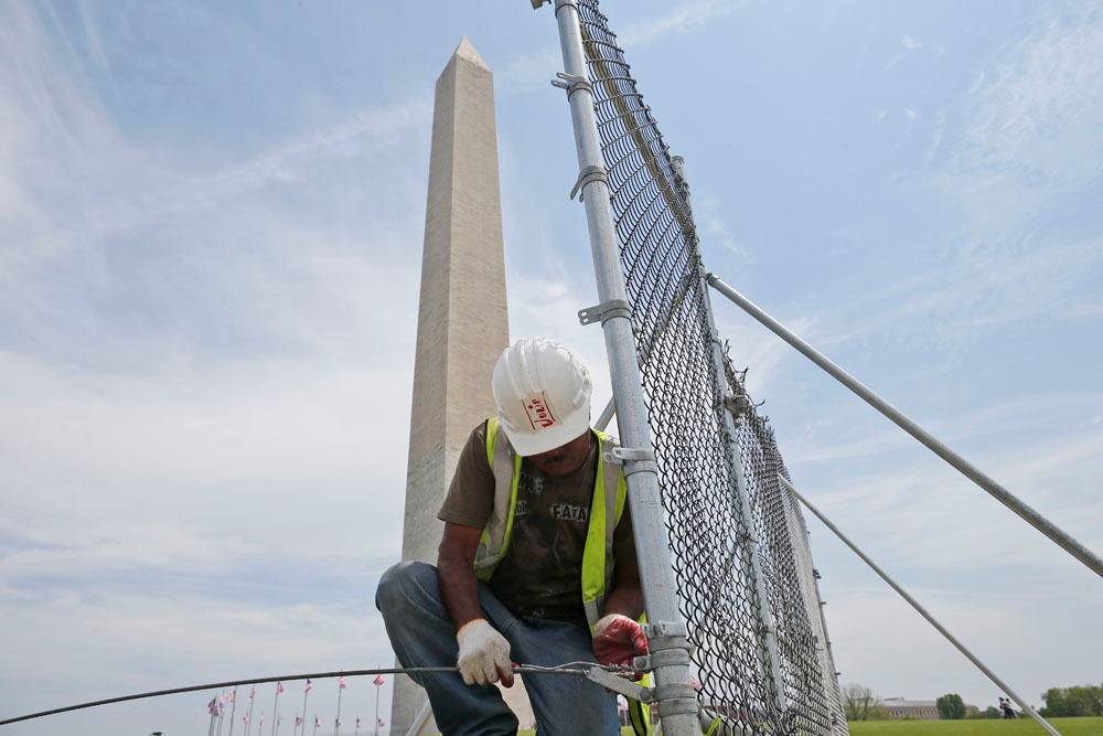 Worker removes fencing at Washington Monument