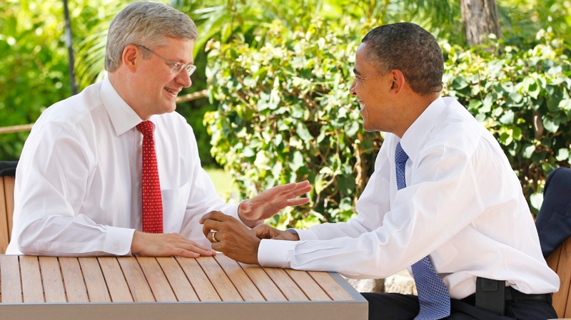 Prime Minister Stephen Harper, left, talks with U.S. President Barack Obama following the first plenary session of the Asia-Pacific Economic Cooperation summit in Kapolei, Hawaii, Sunday, Nov. 13, 2011. (AP / Charles Dharapak)